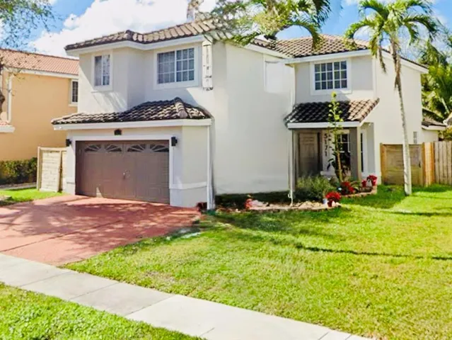 a view of a refrigerator in kitchen and an empty room