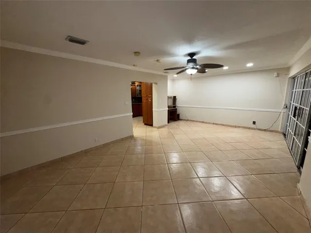 a view of a room with wooden floor and chandelier
