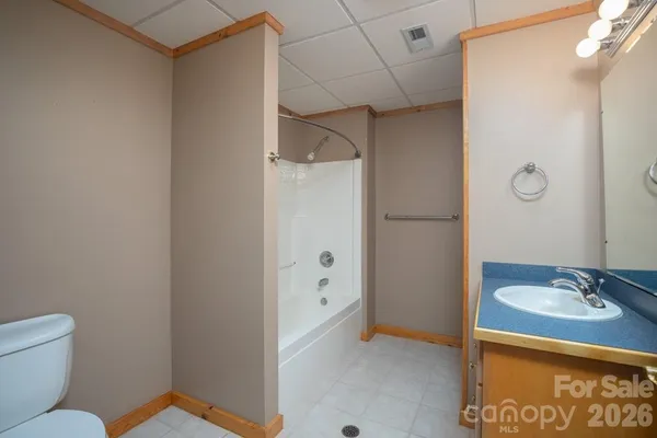 a bathroom with a sink a toilet a shower and a mirror