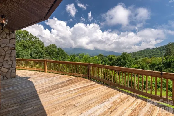 a view of balcony with wooden floor and fence