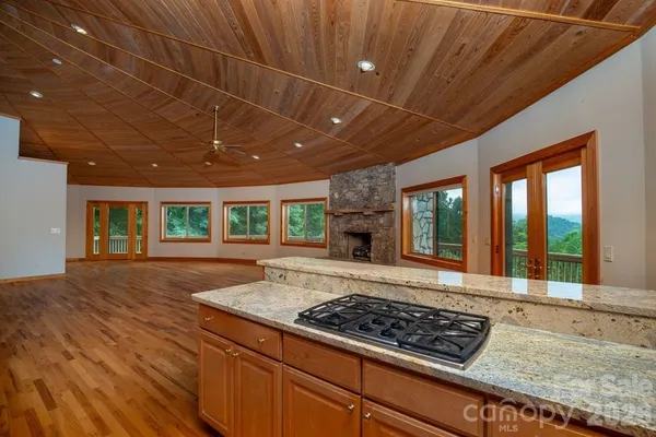 a living room with hard wood floors and a fireplace