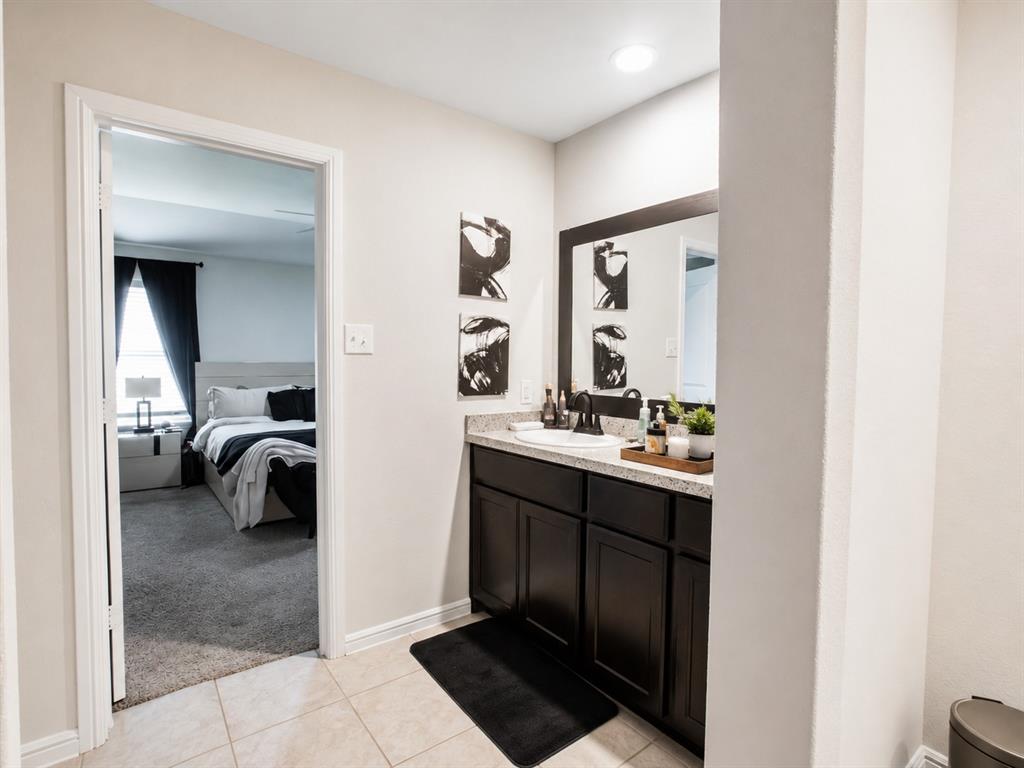 3204 Quiet Valley Road Fort Worth, TX 76123 - Photo 26 of 29 a en suite bathroom with a sink a mirror and a shower