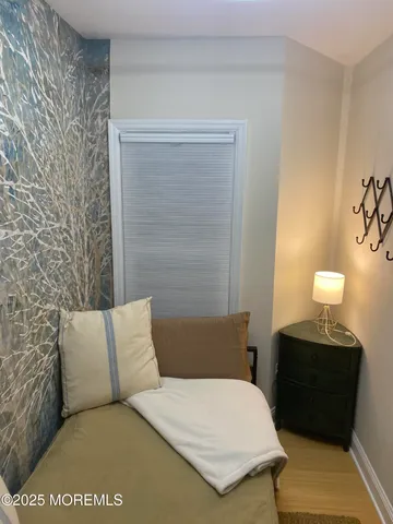 a bedroom with a bed and a night stand