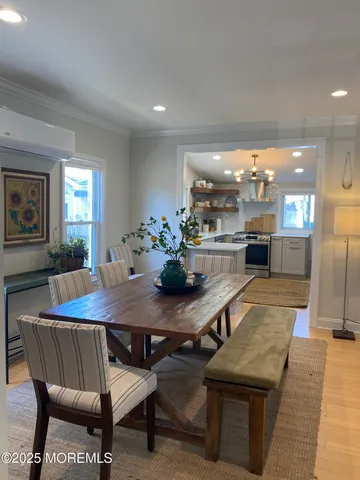 a dining room with furniture and wooden floor