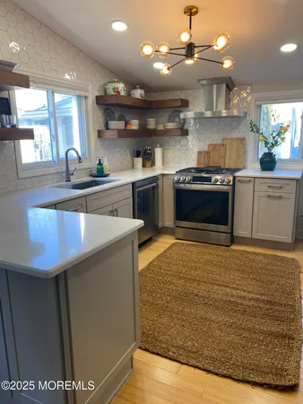 a room with stainless steel appliances wooden cabinets and stove