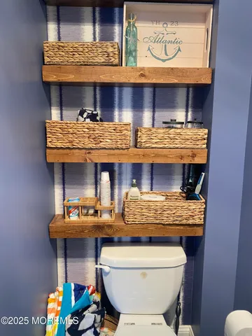a room with stainless steel appliances wooden cabinets and stove