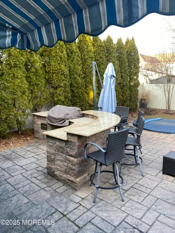 a view of a backyard with table and chairs