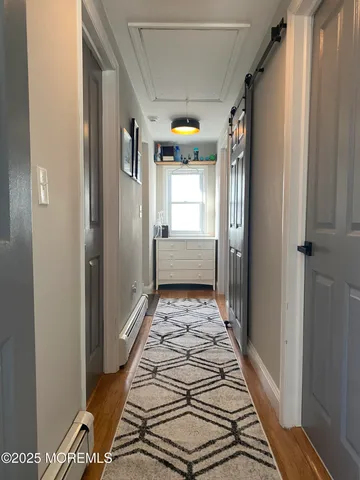 a bathroom with a glass door shower and a sink