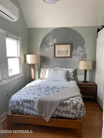 a bedroom with a bed and a lamp