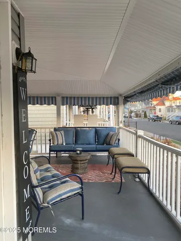 a living room with furniture a window and flat screen tv