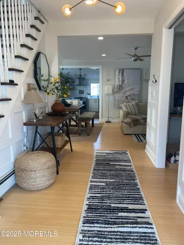 a living room with furniture a rug and a chandelier