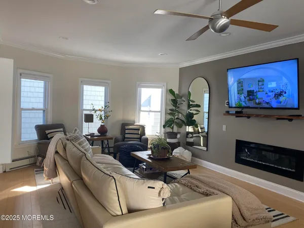 a living room with furniture and a wooden floor