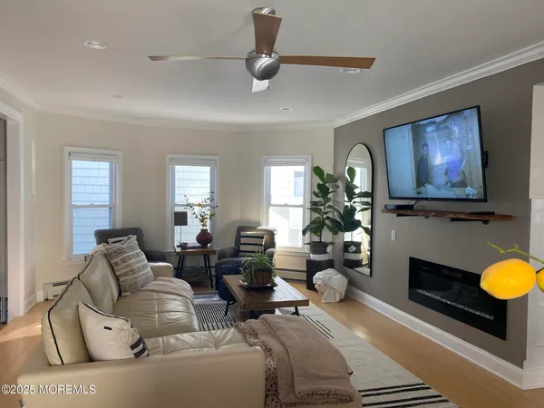 a dining room with furniture and wooden floor