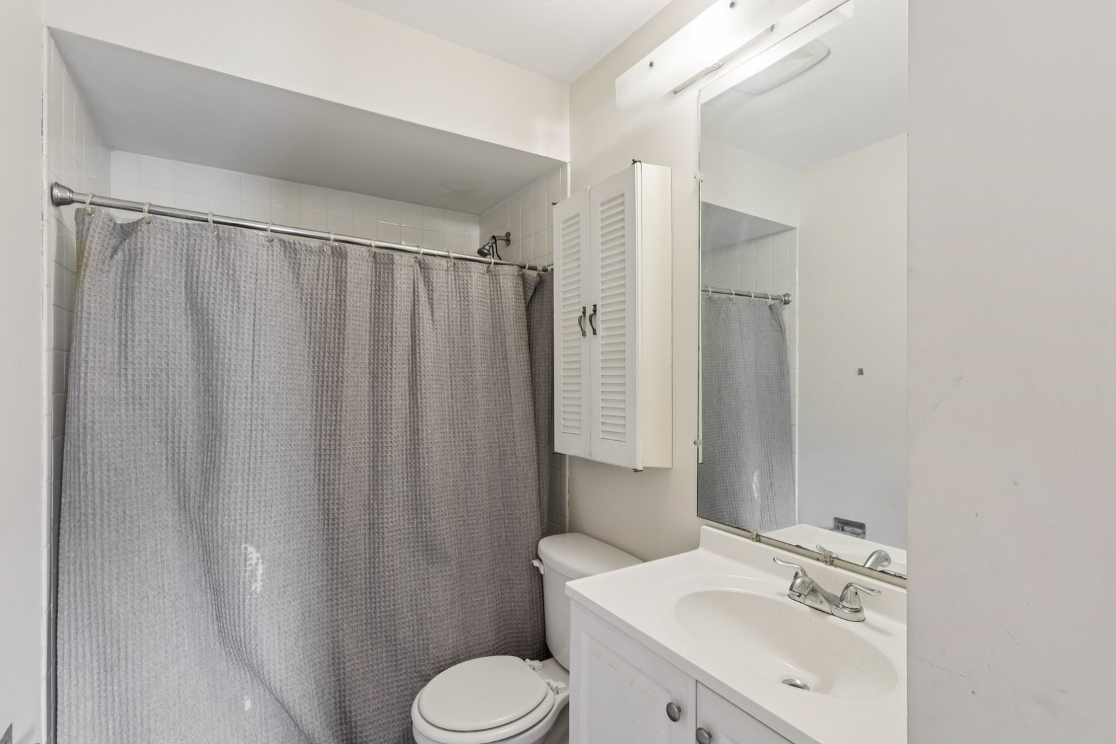7344 Country Creek Way, Unit 8 Downers Grove, IL 60516 - Photo 13 of 17 a bathroom with a sink a toilet and shower curtain
