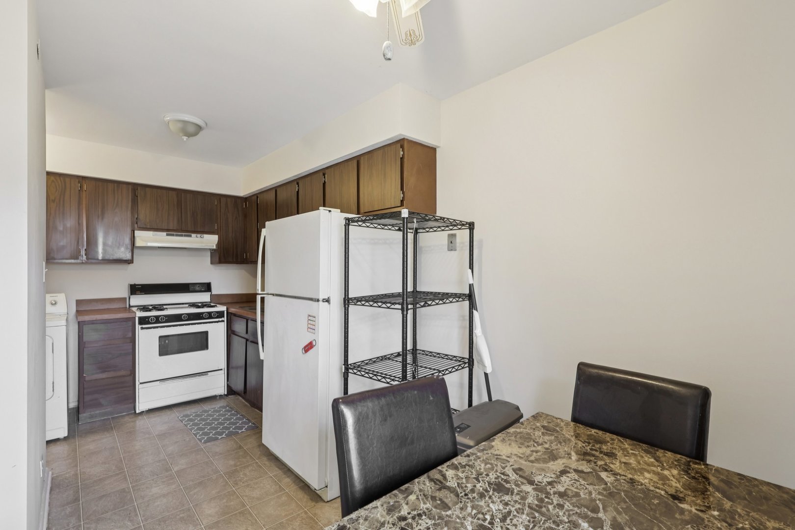 7344 Country Creek Way, Unit 8 Downers Grove, IL 60516 - Photo 10 of 17 a kitchen with stainless steel appliances granite countertop a refrigerator sink and stove
