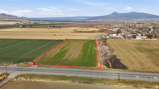 5601 West 15200 North Riverside, UT 84334 - Photo 3 of 10 Overview of rural landscape with mountains, property parcel outlined, and rows of crops