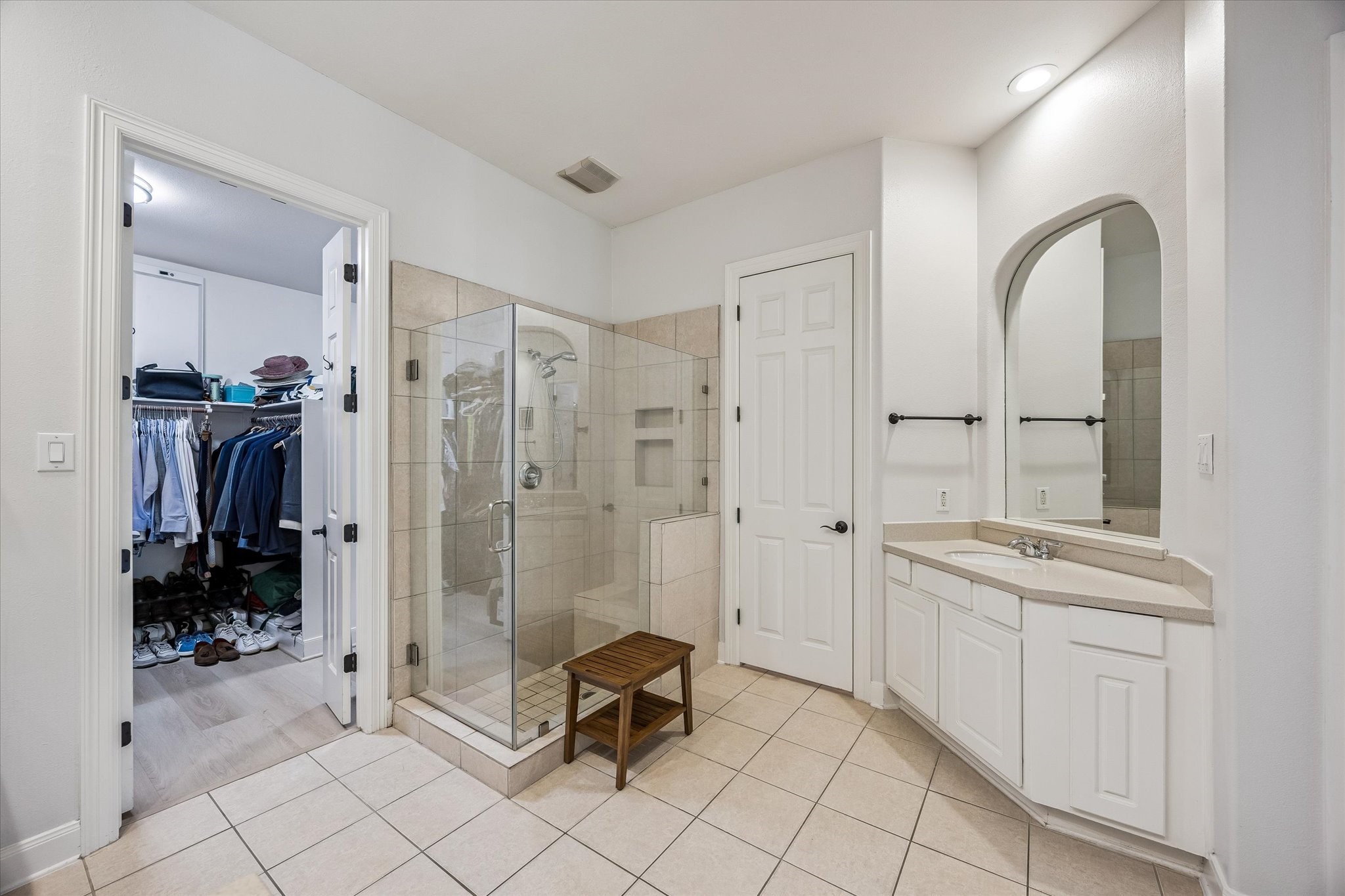 3047 Bonnebridge Way Boulevard Houston, TX 77082 - Photo 38 of 50 The primary bathroom features dual vanities, a glass-enclosed shower with integrated shampoo niches, a private water closet, a linen closet, and a spacious walk-in closet.