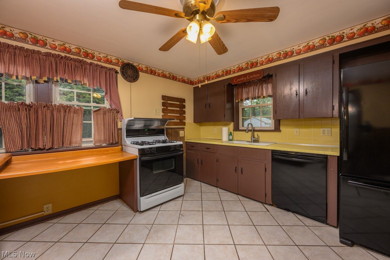 1422 Monument Road Northwest Canton, OH 44703 - Photo 7 of 31 Kitchen with ceiling fan and tile flooring