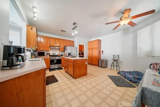 a kitchen with stainless steel appliances granite countertop a refrigerator a oven a sink and dishwasher