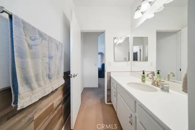 a view of a hallway with closet and a couch