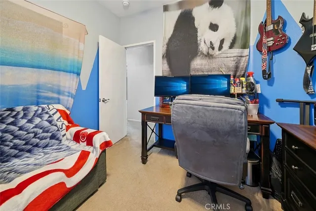 a bedroom with a bed and a book shelf