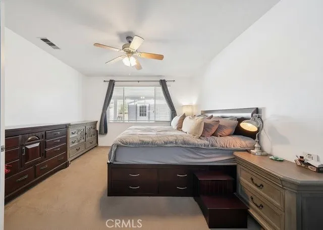 a kitchen with white cabinets and sink