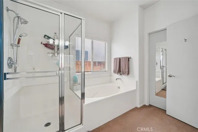 a en suite spacious bathroom with a tub sink and shower