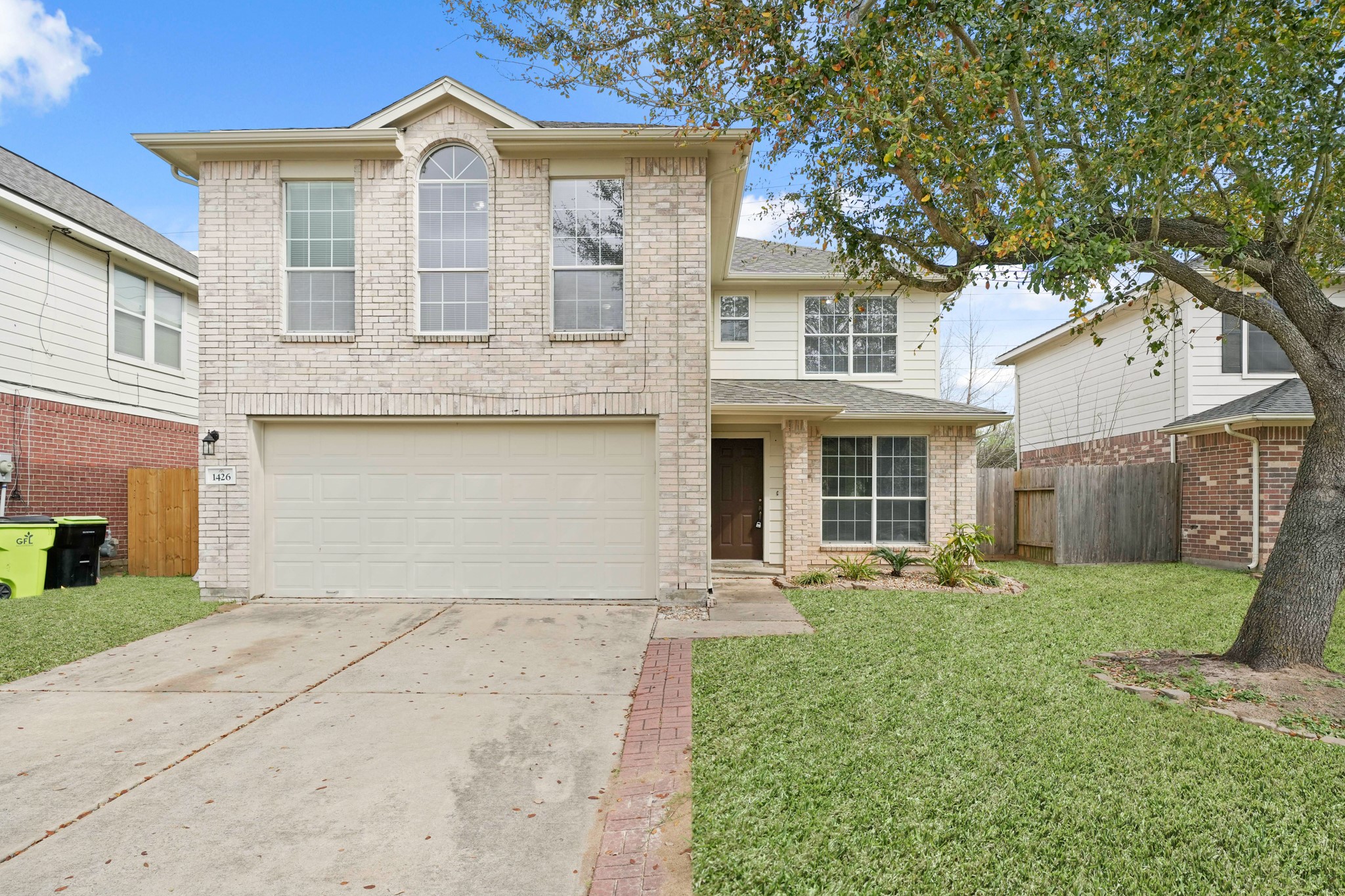 1426 Cartwright Road Missouri City, TX 77489 - Photo 1 of 26 a front view of a house with a yard and garage