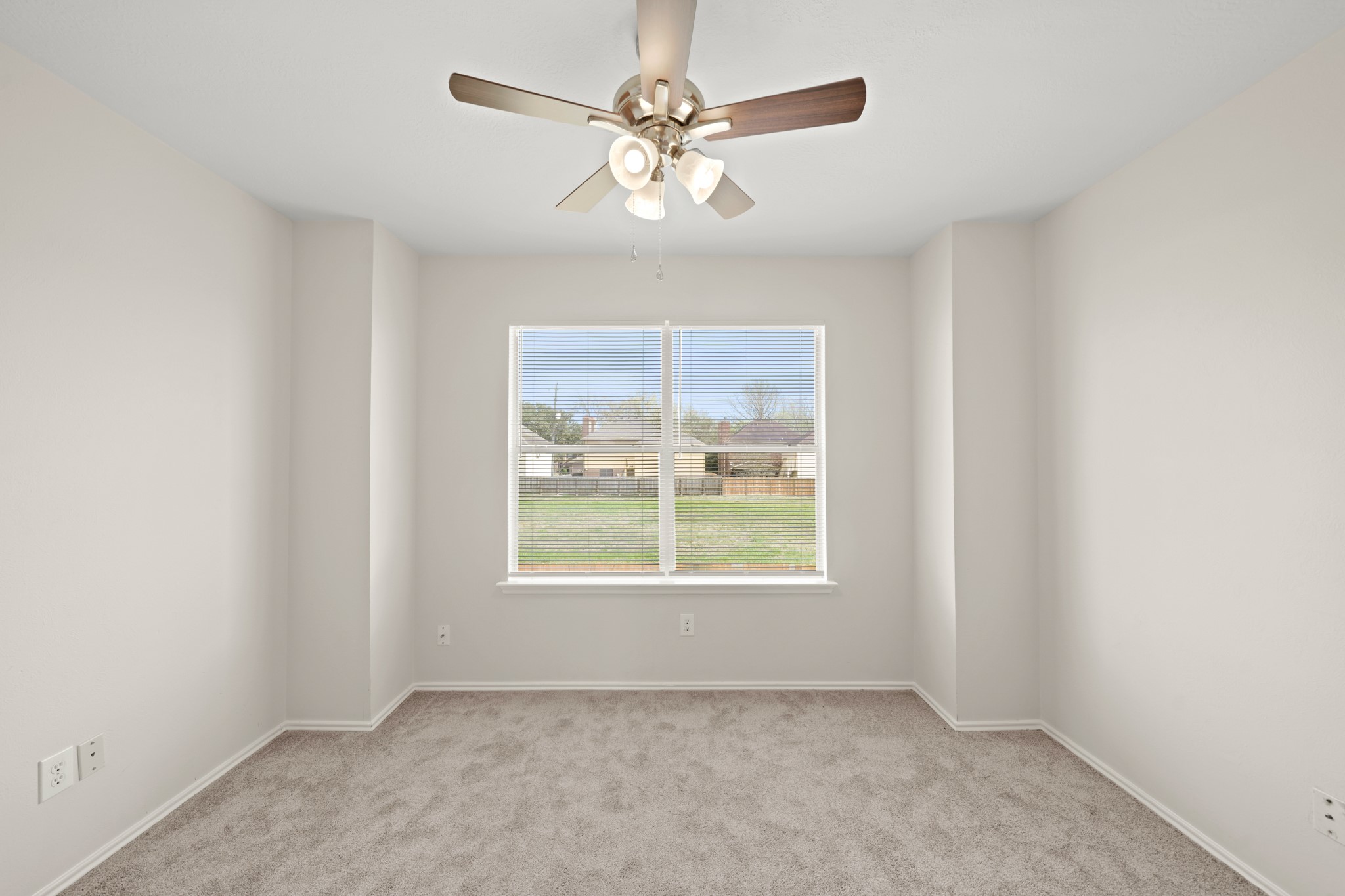 1426 Cartwright Road Missouri City, TX 77489 - Photo 14 of 26 an empty room with windows and fan