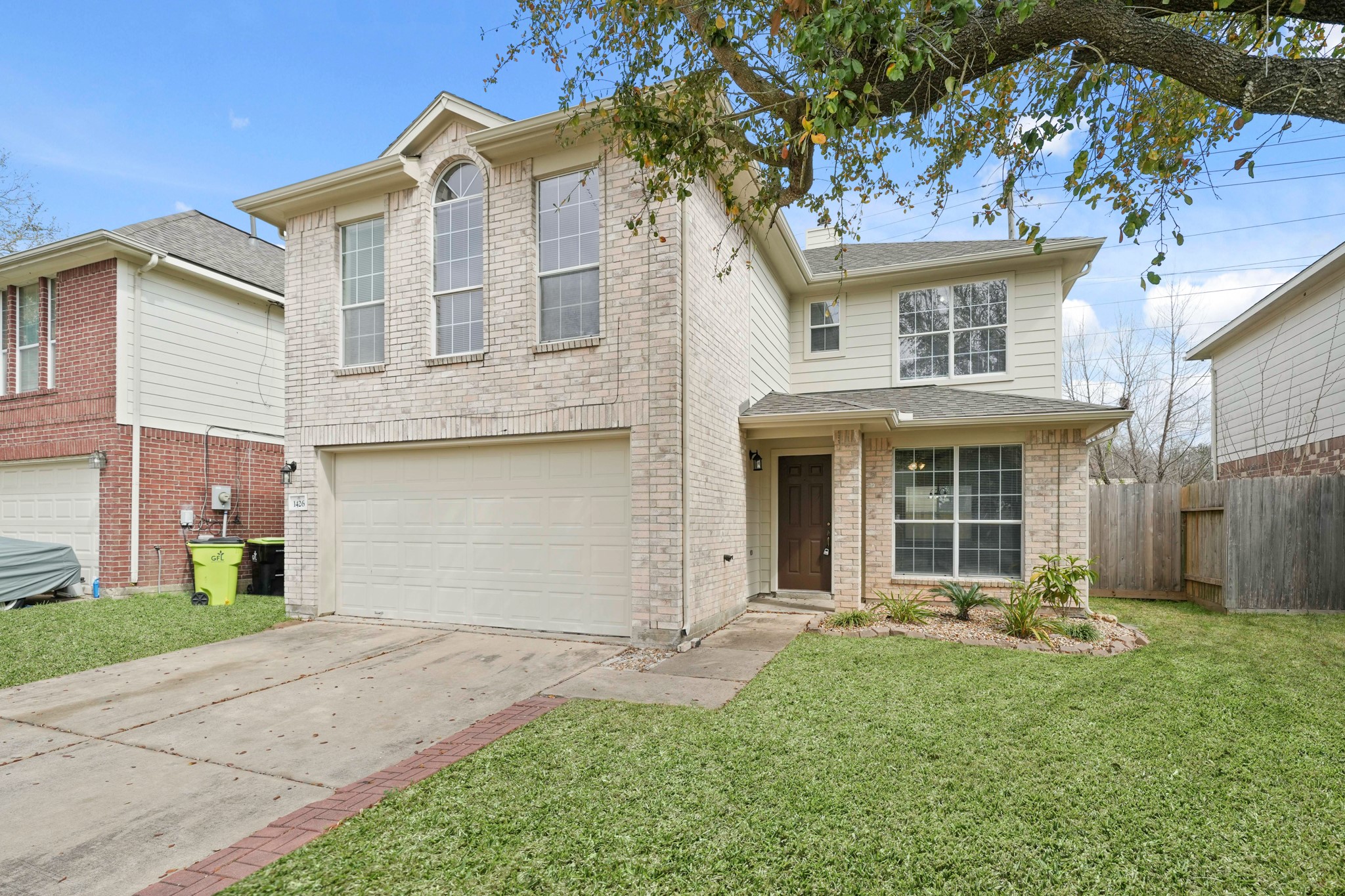 1426 Cartwright Road Missouri City, TX 77489 - Photo 2 of 26 a front view of a house with a yard and garage