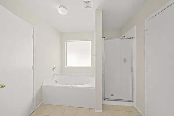 a white bath tub sitting next to a shower