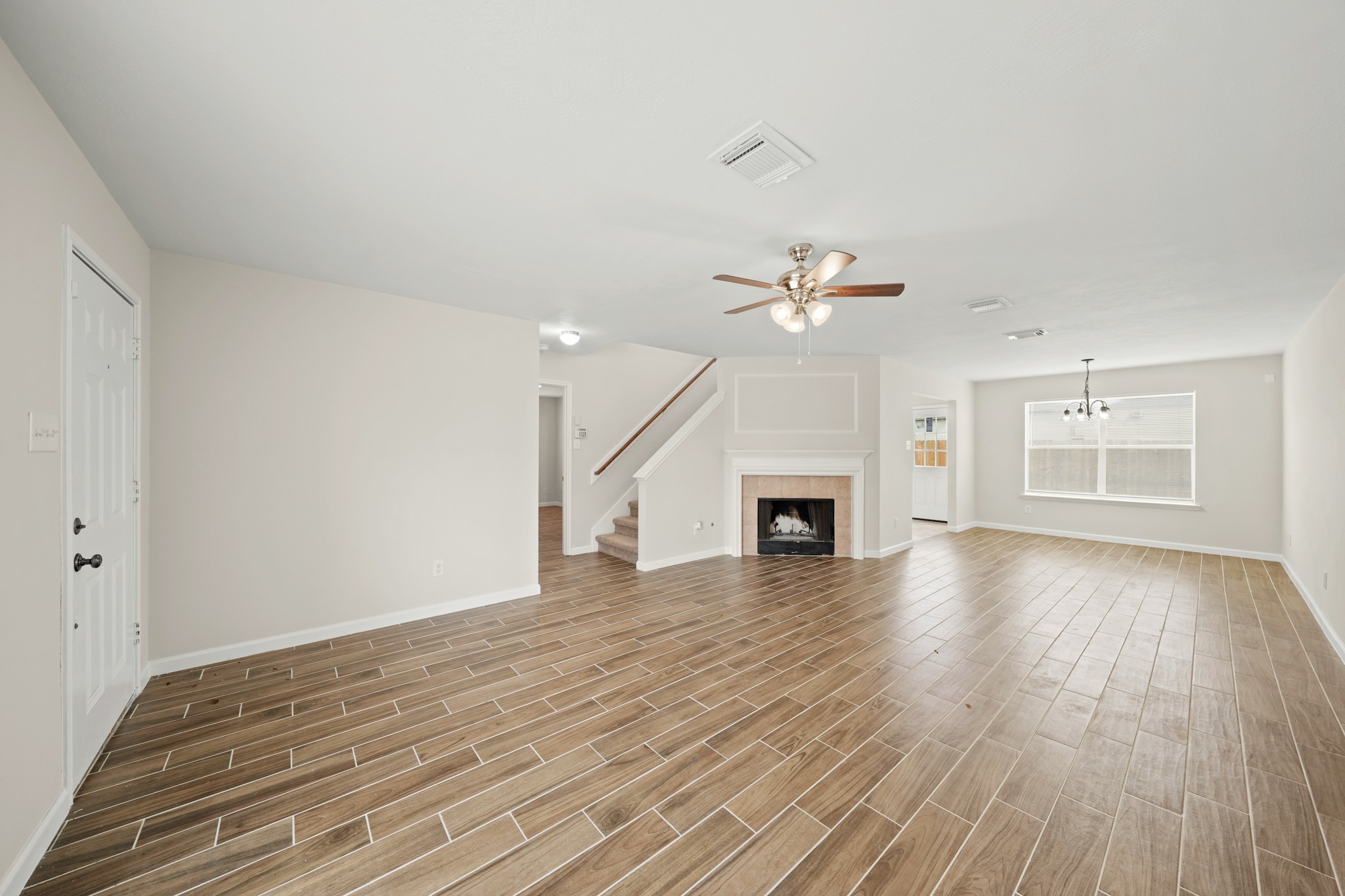 1426 Cartwright Road Missouri City, TX 77489 - Photo 5 of 26 a view of empty room with wooden floor and fireplace
