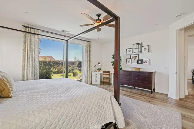 a bedroom with a bed and a potted plant