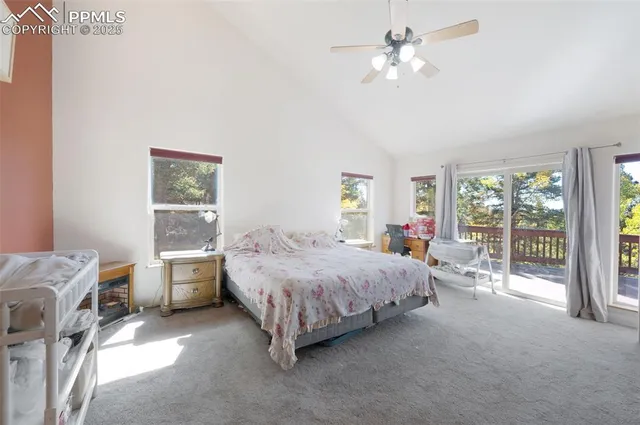 a spacious bedroom with a bed and a chandelier