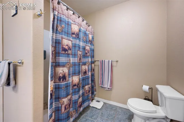 a bathroom with a toilet and shower