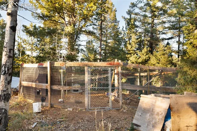 a view of a patio with table and chairs and floor to ceiling window