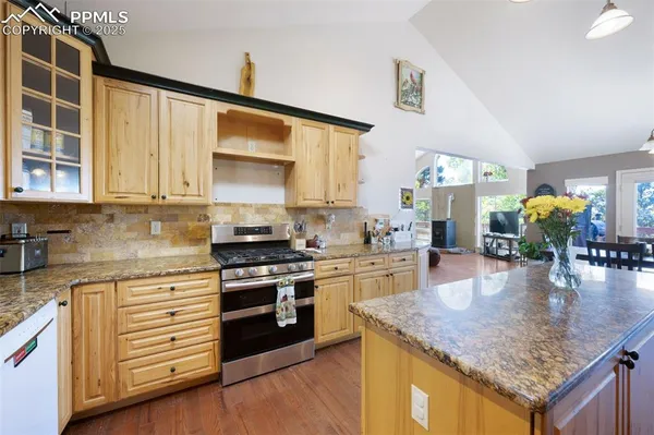 a kitchen with sink stove and cabinets