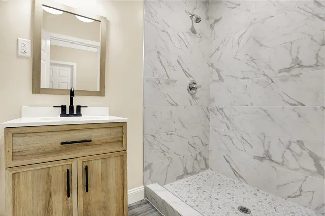 a bathroom with a sink vanity and a mirror