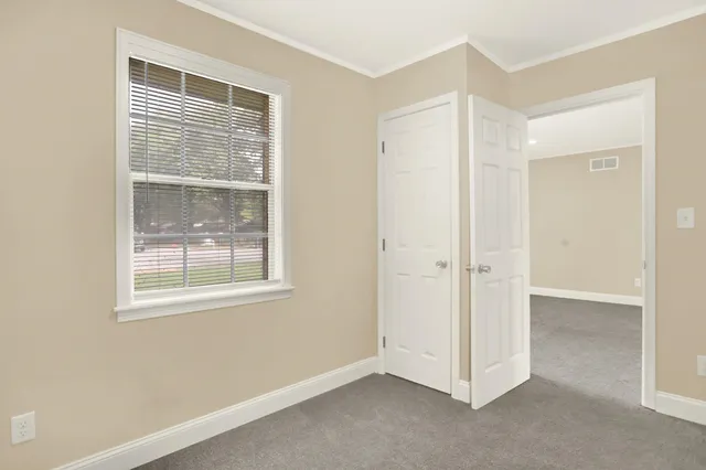 a view of an empty room with a window