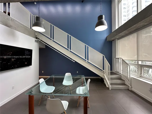 a dining room with furniture and a flat screen tv