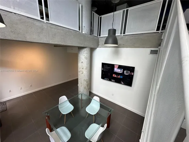 a living room with chairs and a fireplace