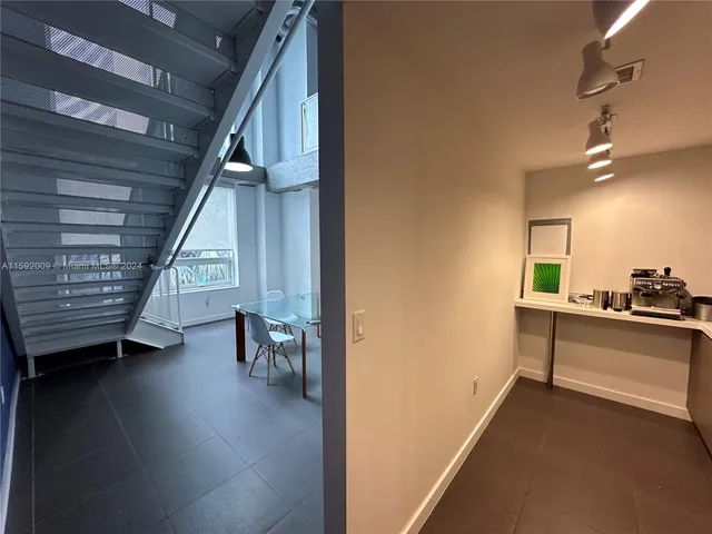a view of a hallway with stairs and furniture
