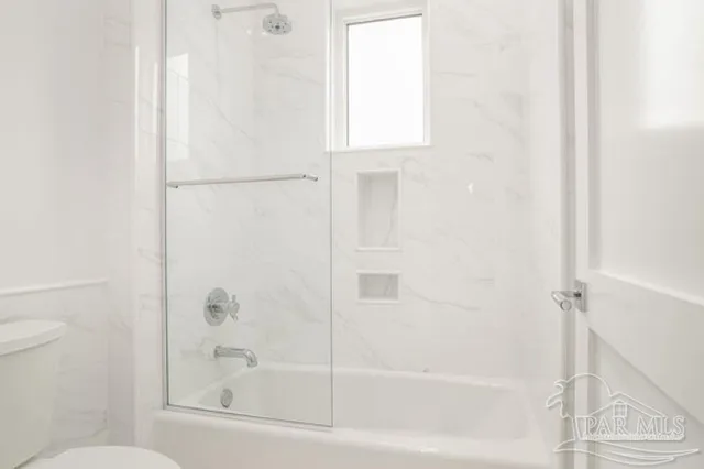 a living room with patio furniture and a large window