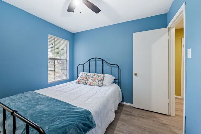 a bedroom with a bed and a window