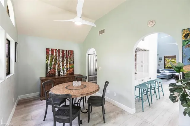 a view of a dining room with furniture and a potted plant