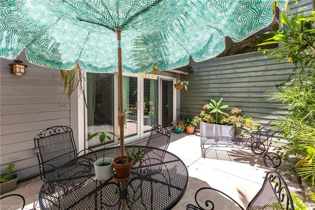 a view of a patio with couple of chairs and a table