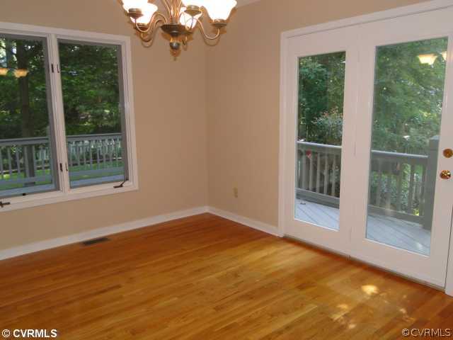 15000 Walnut Bend Road Midlothian, VA 23112 - Photo 8 of 24 a view of empty room with wooden floor and fan