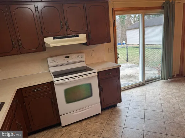 a kitchen with a stove and a cabinets