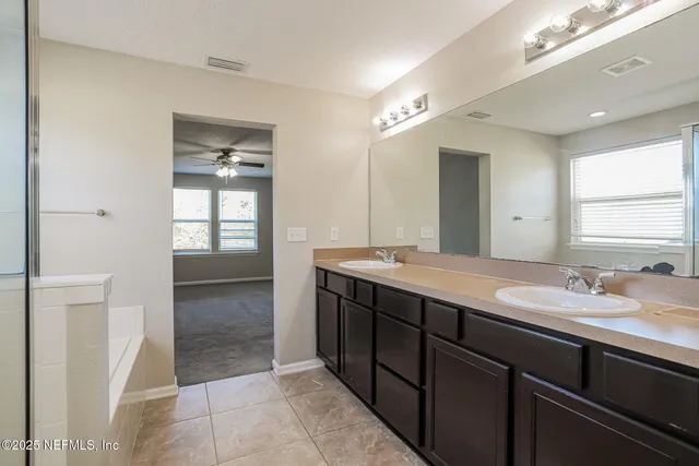a bathroom with a sink double vanity and a mirror