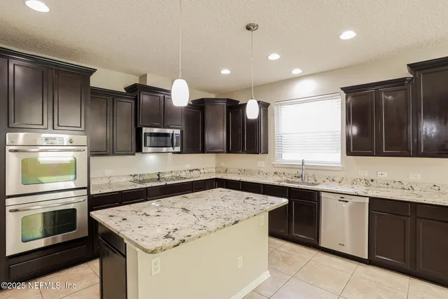 a kitchen with a sink stove and microwave